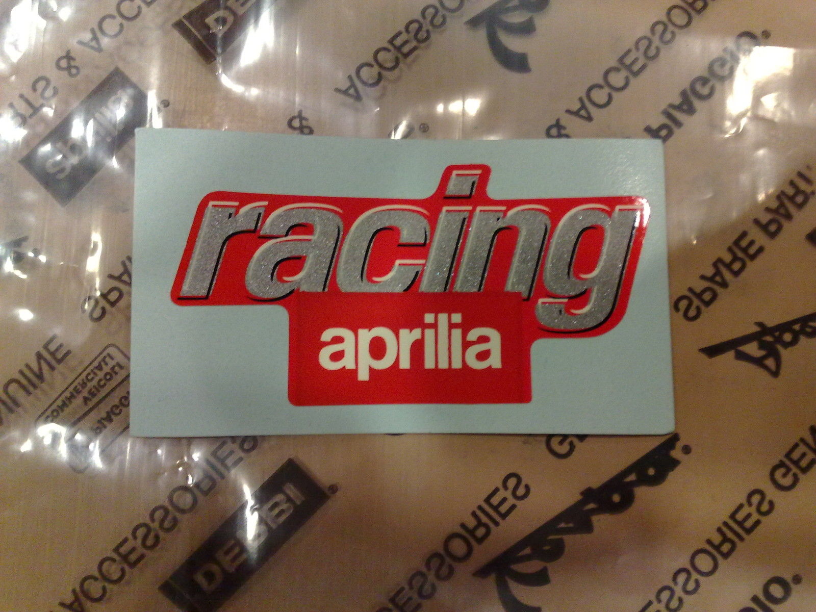 ADESIVO DECALCO APRILIA RACING ORIGINALE MISURE 5.5 x 2.9 CM CODICE AP8157124